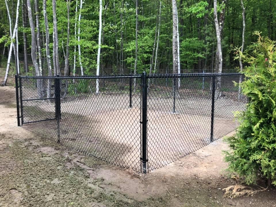 152285557_362113174961082_532180576136983160_n Chain link fence in wooded area.