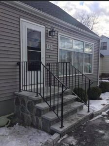 House entrance with steps and railing.