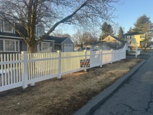 White picket fence along suburban street.