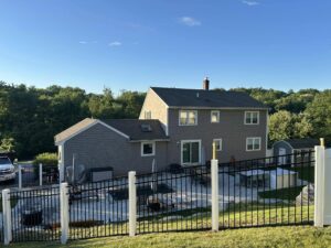 Two-story house with a fenced backyard.