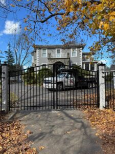 House with gated driveway and parked truck.
