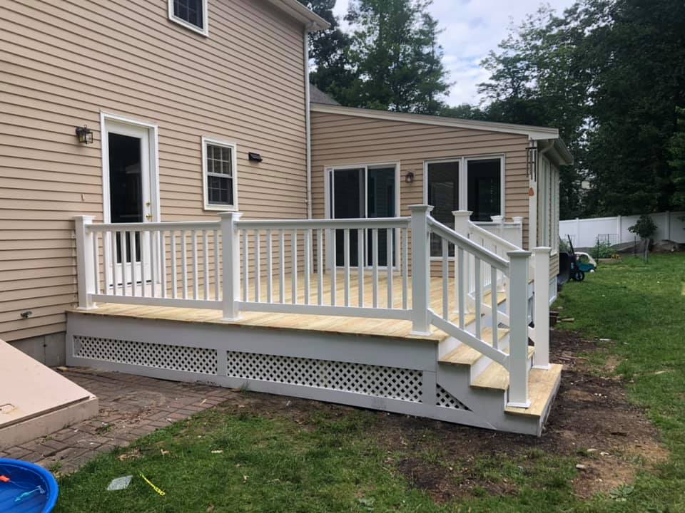 469331877_1434643704374685_4397955833171932012_n Wooden deck with white railing and stairs.