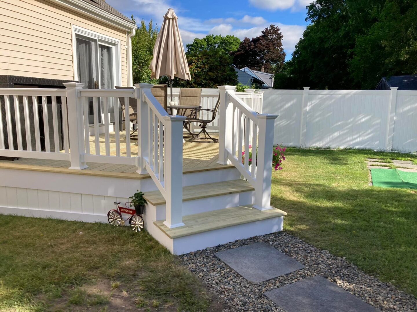480494269_1492303738608681_2973542798815141055_n Backyard deck with steps and umbrella.