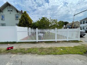 White picket fence in residential neighborhood.